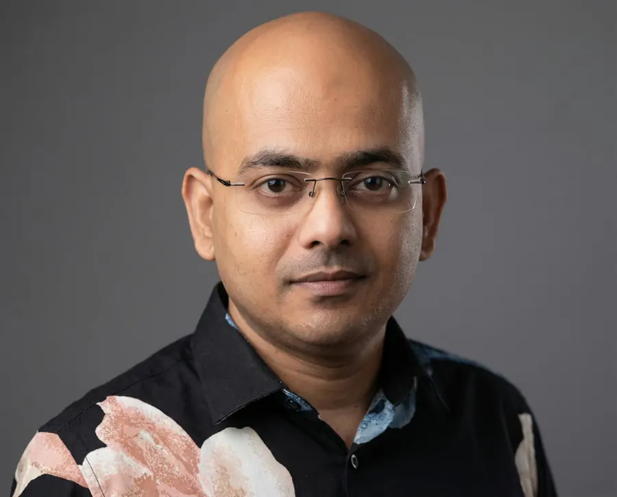 Jewel Chanda in a floral shirt, studio portrait